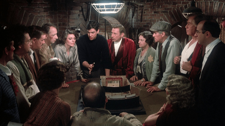 Tim Matheson laying out a plan to Mel Brooks, Anne Bancroft, and the rest of their acting troupe