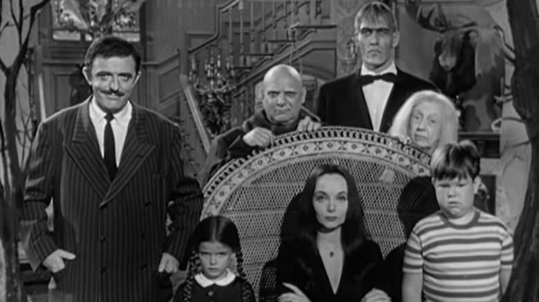 The Addams Family seated in home