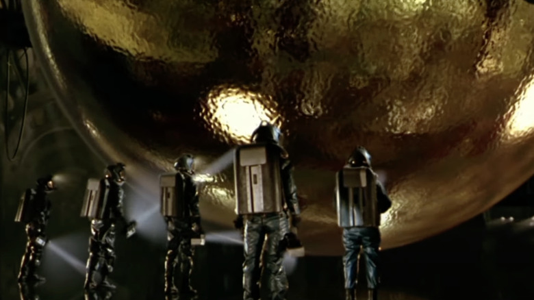 Scientists examine an alien sphere in Sphere
