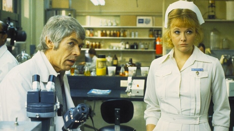 Dr. Peter Carey (James Coburn) talks to Nurse Angela (Skye Aubrey) in The Carey Treatment
