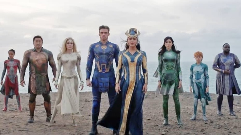 Eternals cast standing on beach