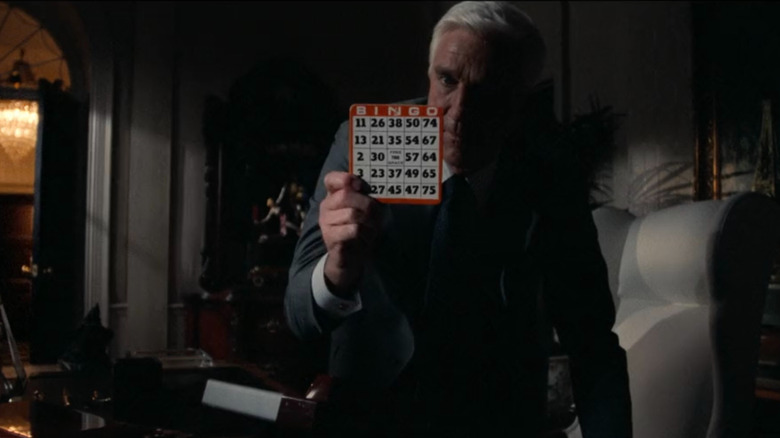 Frank Drebin holding up a bingo card in The Naked Gun: From the Files of Police Squad