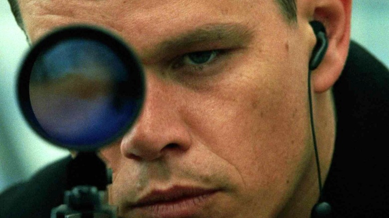 Matt Damon aims sniper rifle Bourne Supremacy