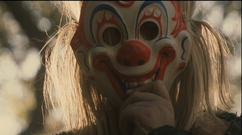 Michael Myers puts on a clown mask