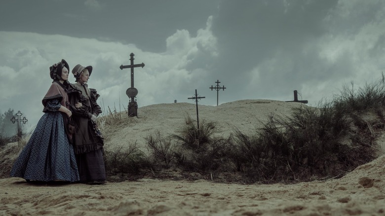 Ellen and Anna walk through a cemetery by the sea in Nosferatu (2024)