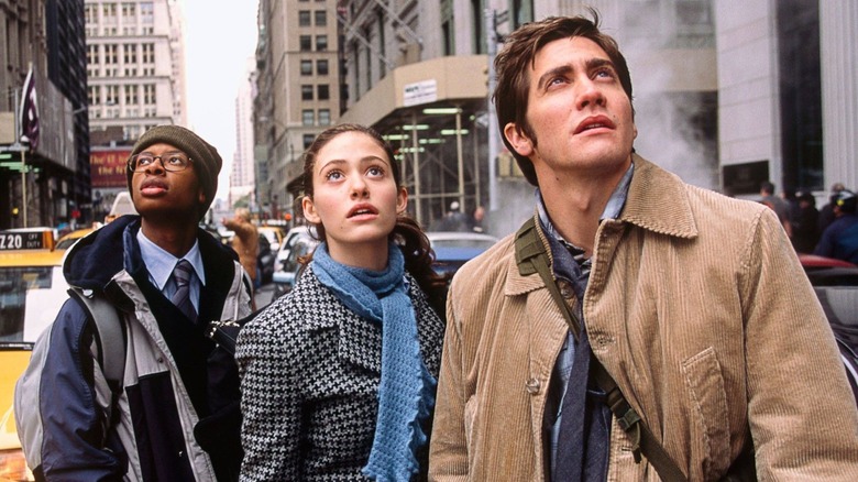Three young people in NYC look up worriedly