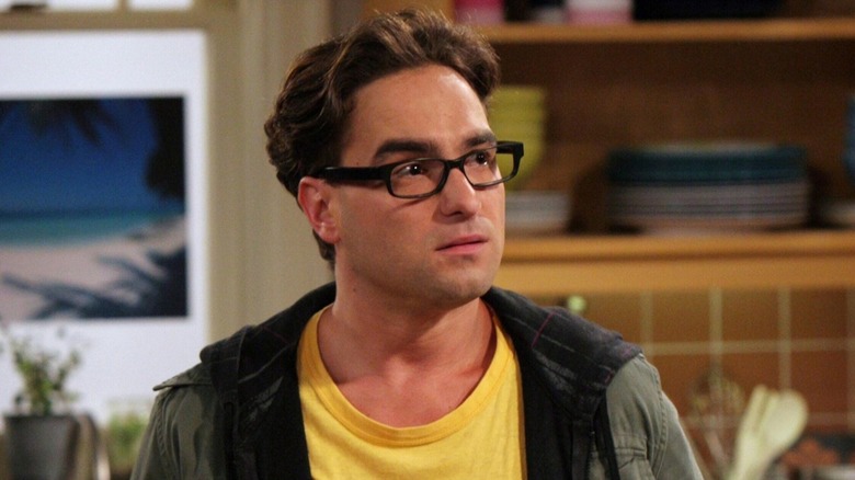 Johnny Galecki as Leonard Hofstadter wearing a hoodie and yellow shirt on The Big Bang Theory