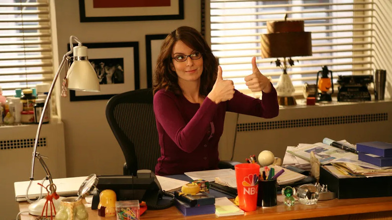 Liz Lemon giving a thumbs up in her office on 30 Rock
