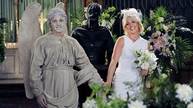 Paul dressed as an angel and Jenna in a wedding dress with a masked man marrying them on 30 Rock