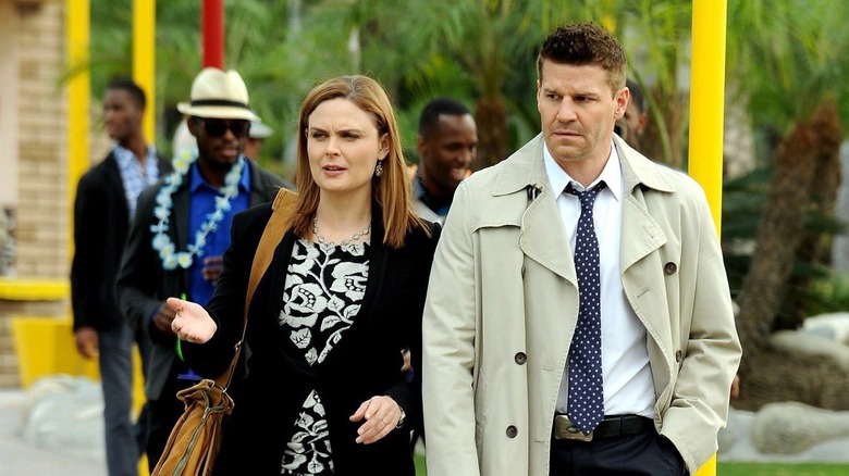Emily Deschanel as Brennan stands next to David Boreanaz as Booth in Bones