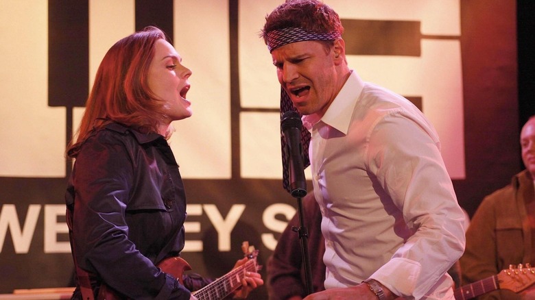Emily Deschanel as Brennan sings next to David Boreanaz as Booth in Bones