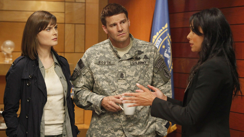 Emily Deschanel as Brennan stands next to David Boreanaz as Booth and Tamara Taylor as Cam in Bones