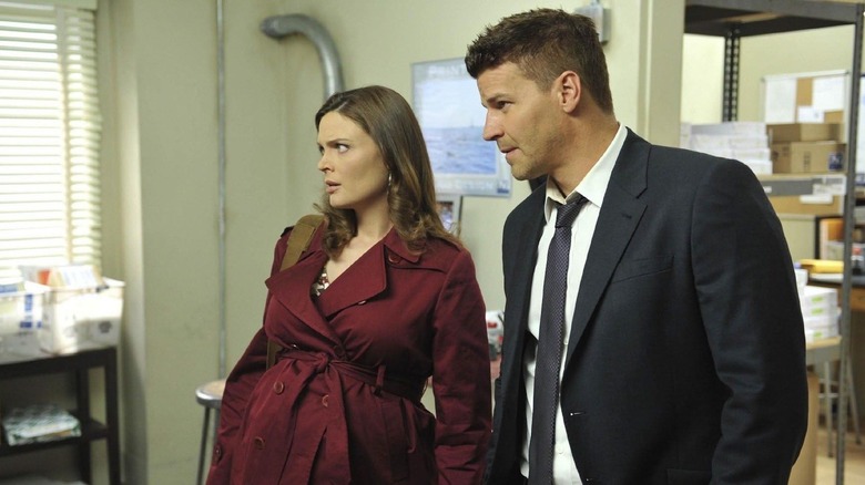 Emily Deschanel as Brennan stands next to David Boreanaz as Booth in Bones