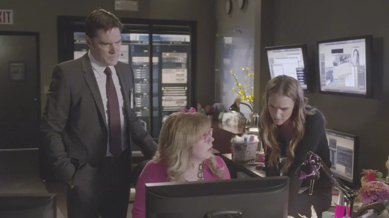 Criminal Minds' Hotch, Garcia, and JJ looking at monitor
