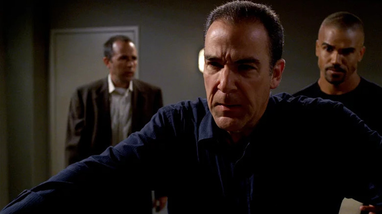 Rossi standing in front of Morgan and other man
