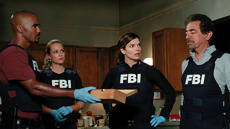 Criminal Minds' Morgan, JJ. Blake, and Rossi standing in house