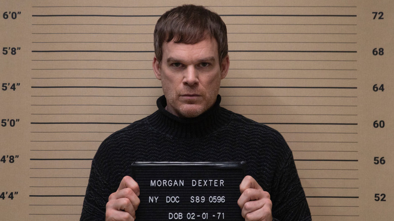 Michael C. Hall as Dexter,  posing for a mugshot on Dexter: New Blood