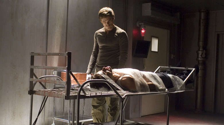 Michael C. Hall as Dexter, standing over Brian's body on Dexter