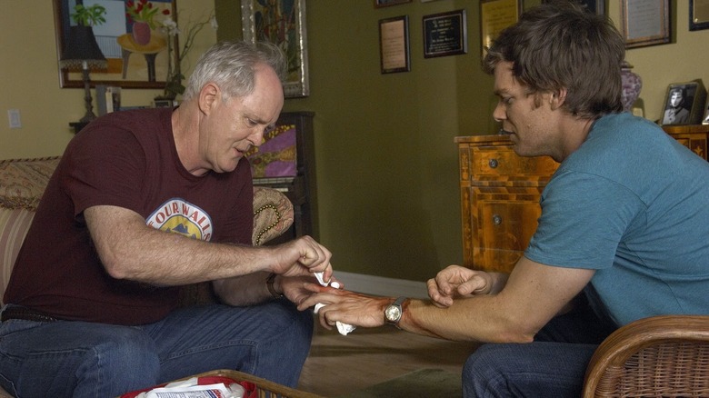 John Lithgow and Michael C. Hall as Arthur and Dexter, tending to a wound on Dexter
