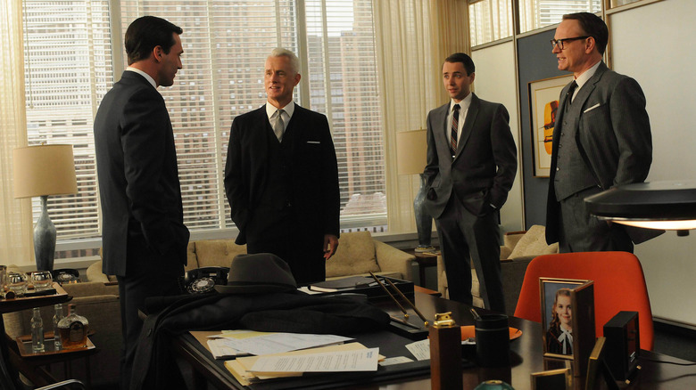 Don talking with partners in office
