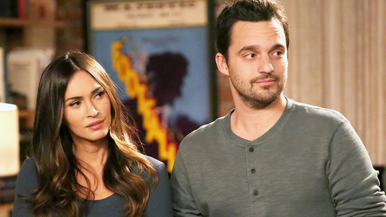 Reagan and Nick looking at someone on New Girl