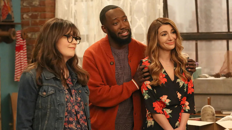 Jess standing next to Winston and Aly in the loft in New Girl