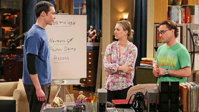 Sheldon Penny and Leonard in front of a whiteboard on The Big Bang Theory