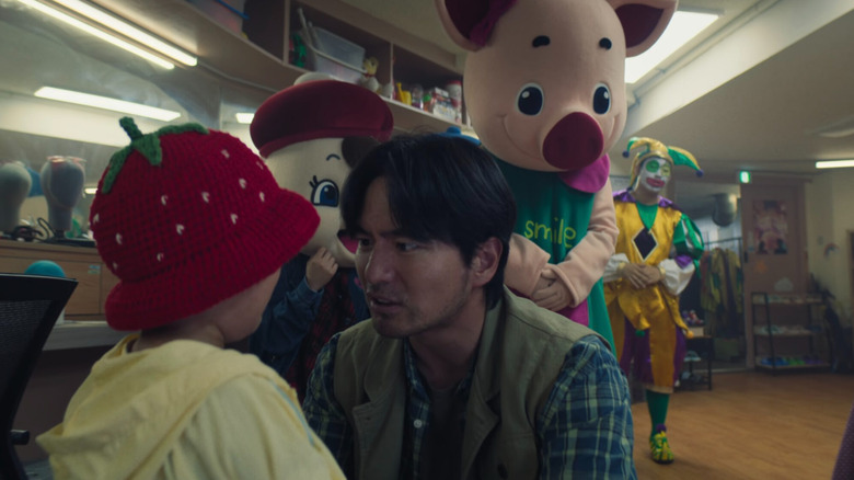 Gyeong-seok talking to his daughter at the amusement park dressing room on Squid Game