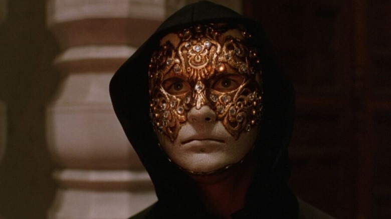 Bill Harford (Tom Cruise) wears a Venetian mask and black hook in Eyes Wide Shut