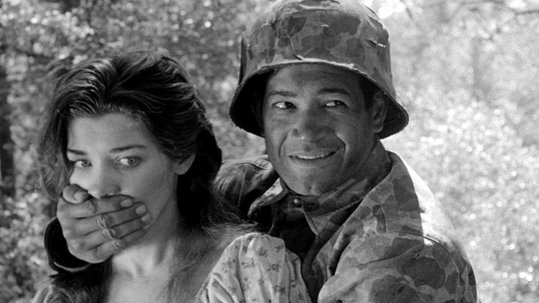 Mac (Frank Silvera) covers the mouth of the girl (Virginia Leith) in Fear and Desire