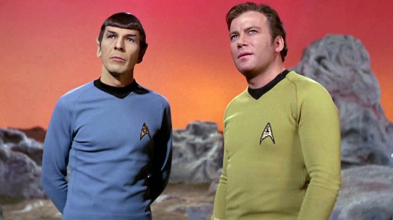 Spock (Leonard Nimoy) and Kirk (William Shatner) stand on an alien planet in Star Trek