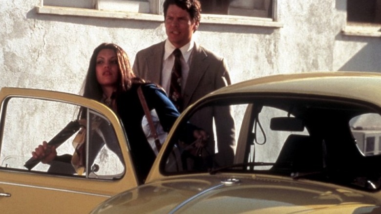 michael reilly burke as ted bundy helps woman out of car