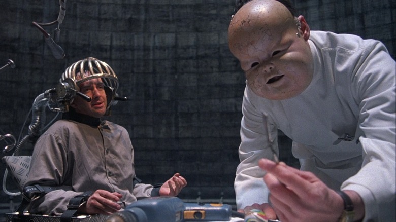 Jonathan Pryce in Brazil strapped in chair baby mask
