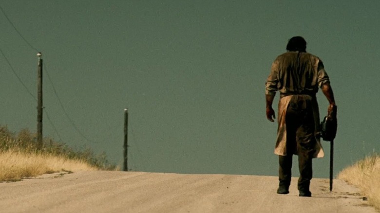 Leatherface walking down a dirt road