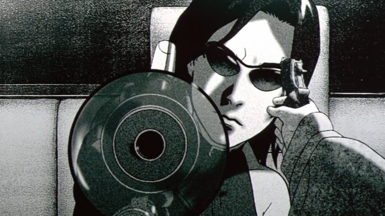 Trinity pointing a gun while another gun is pointed at her head in The Animatrix