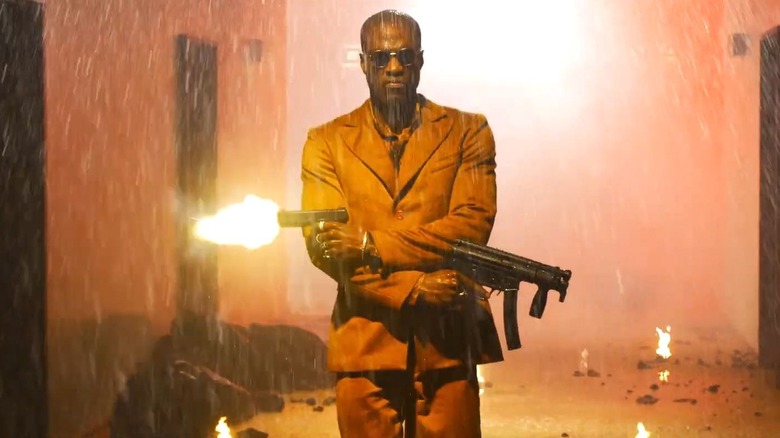 Morpheus shooting two guns in a hallway in The Matrix Resurrections