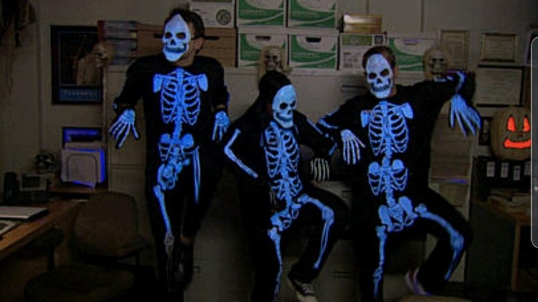 Three Office employees dressed as skeletons