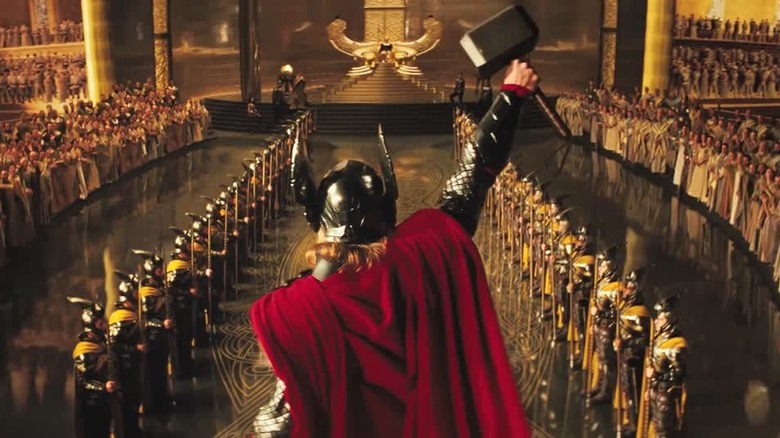 Thor (Chris Hemsworth) shown from behind cheering Asgardian toops in Thor