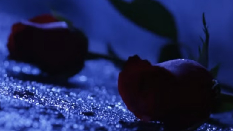 Batman Forever roses lying on alley ground