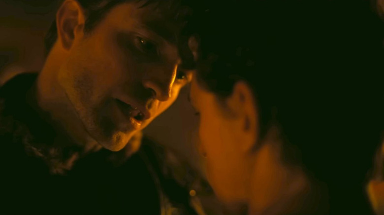 Antinous leaning in close to talk to Telemachus in The Pdyssey
