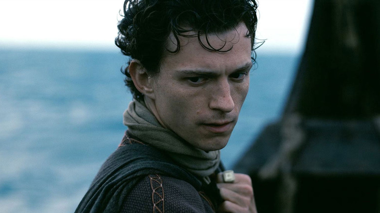 Telemachus in a boat looking intense in The Odyssey