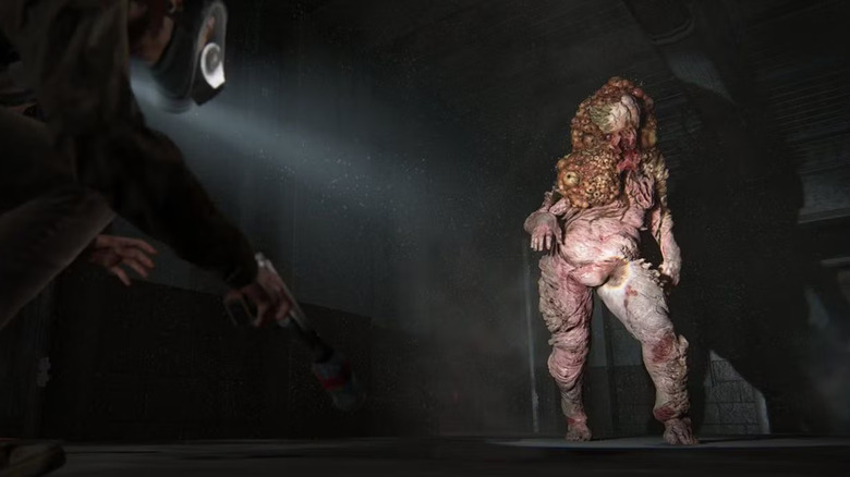 A Cordyceps shambler standing in a beam of light in The Last of Us: Part II