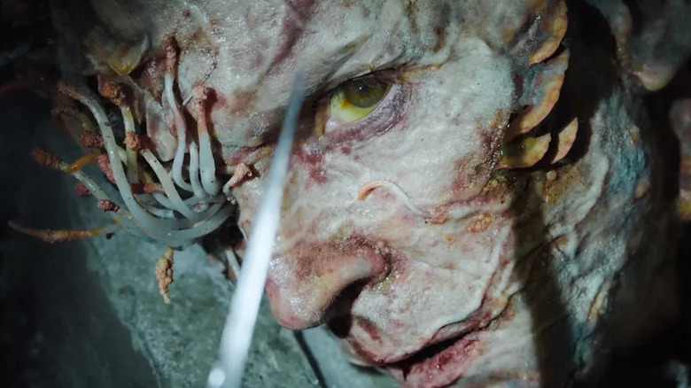 Infected human with spores growing out of his eyes on The Last of Us