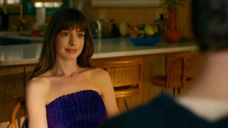 Solène sitting on a chair in The Idea of ​​​​You
