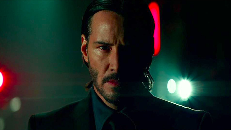 Keanu Reeves as John Wick in half-shadow in John Wick