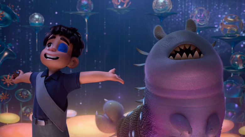 Elio in an eyepatch and an eyeless alien creature looking up in Elio (2025)
