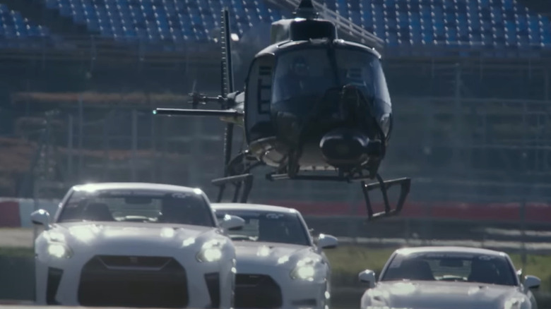 A helicopter follows cars