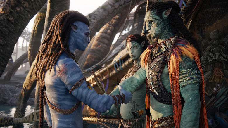 Sam Worthington, Kate Winslet, and Cliff Curtis in Avatar: The Way of Water
