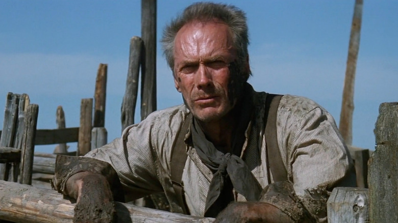 Will Munny standing over a farm fence in Unforgiven