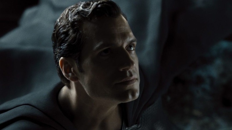 Henry Cavill as Superman in a black suit looking up in Justice League: The Snyder Cut